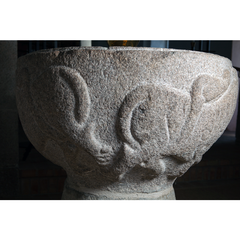 the rumps of the two lions that are set to the sides of the human head; notice the artistic tuft of the tail end