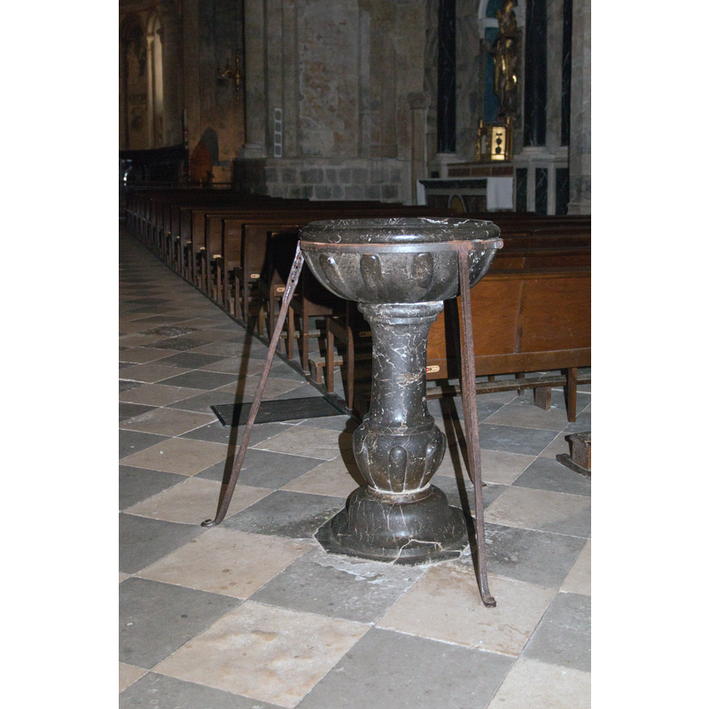 modern stoup at the west end of the nave
