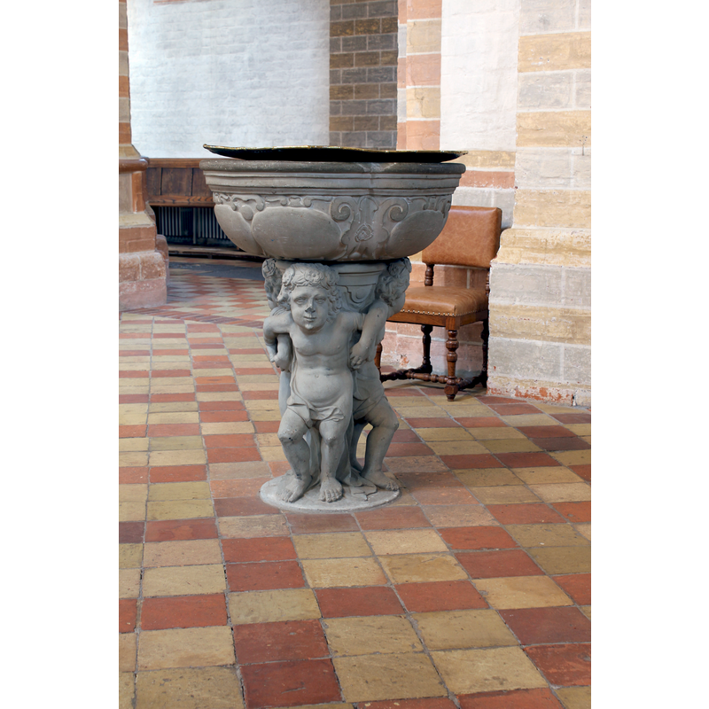 the modern font with the metal baptismal dish atop