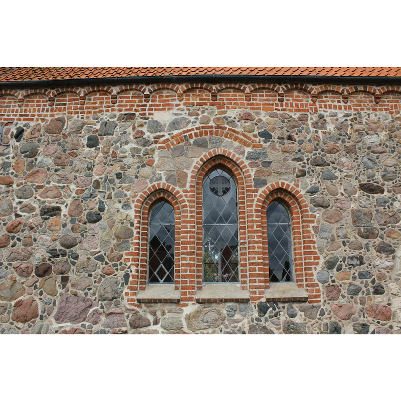 set of windows located on the north wall, between the porch (left) and the tower (right)