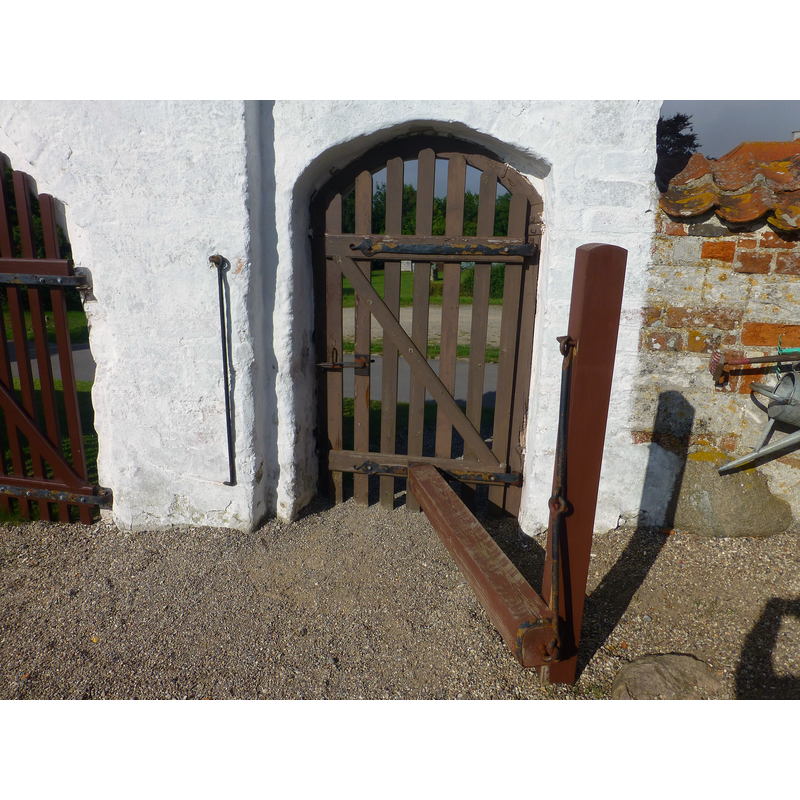 the weight of the ingenious battering-ram like contraption keeps the gate closed -- viewed from inside the churchyard