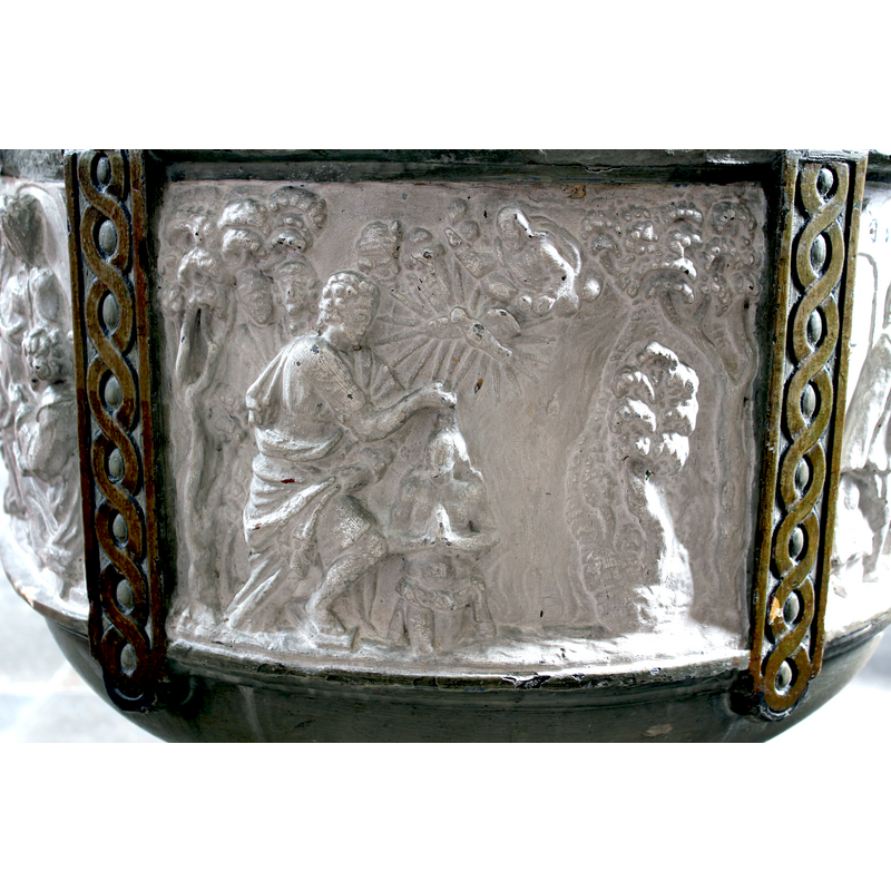 a series of circles [a cloud?] separates God the Father [above] and the Holy Ghost [below]; John the Baptist towerse over a small kneeling Chirst; several figures mixed amid the vegetation in the background