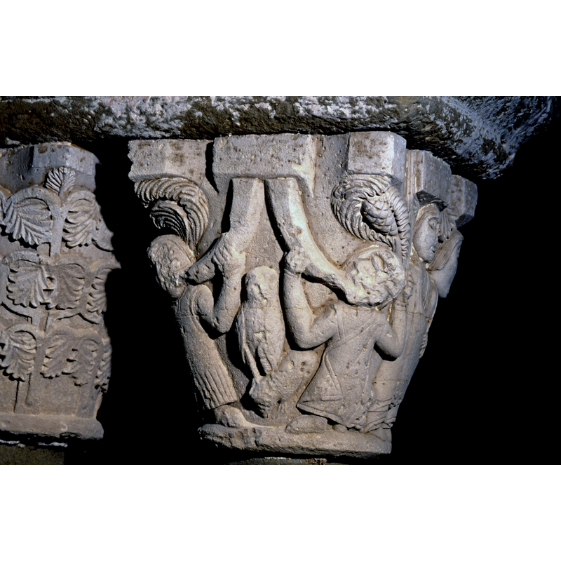 inner capital on the west side; two figures blowing horns with an owl (?) between them on this side; on the adjacent side to the right is a married couple