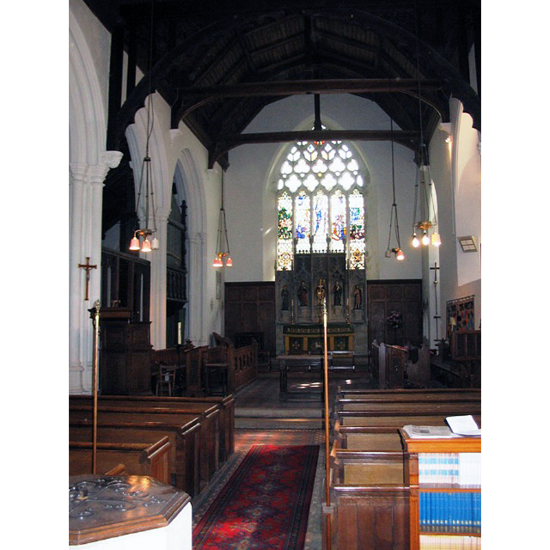 Source caption: "All Saints Church, Long Marston – Interior. At the time it was decided to demolish the old church and build this one there was a major restoration of Tring Parish Church in progress. As a result the clustered columns, high moulded bases and the organ came from Tring." -- the baptismal font is partially visible in the foreground, left side
