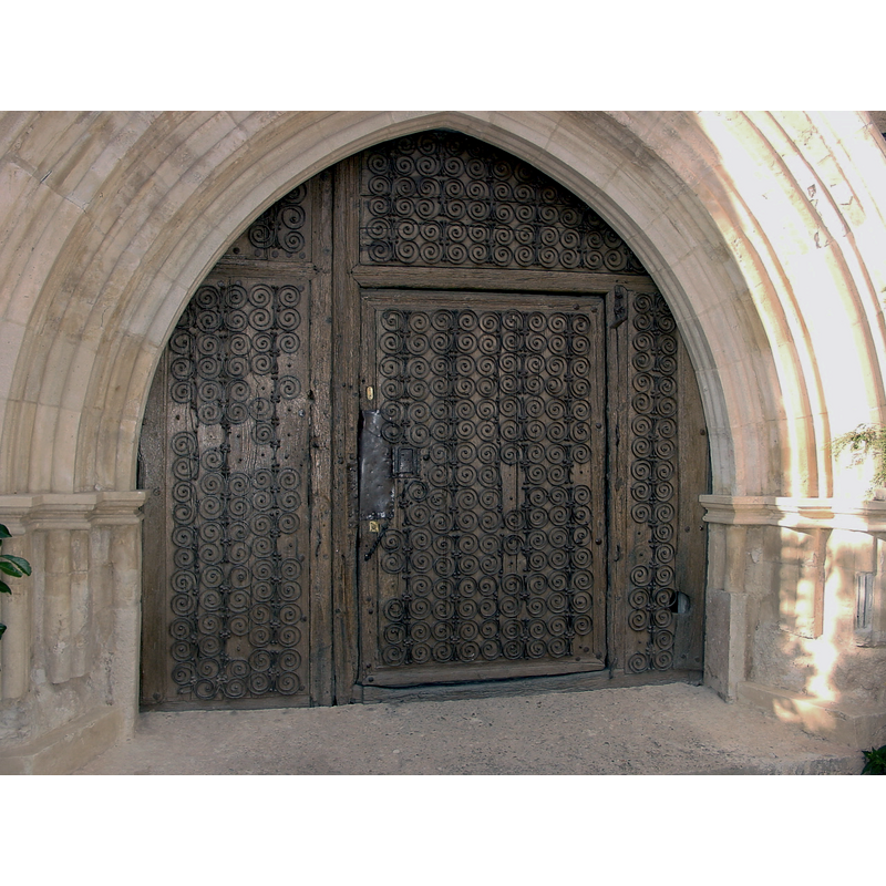 showing some fancy ironwork on the door frame and panels