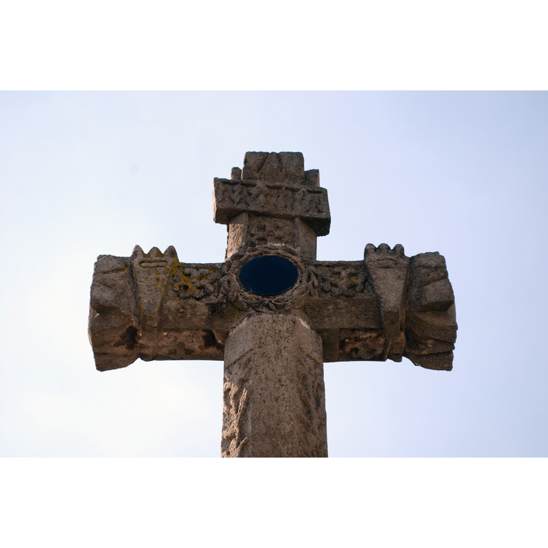 Source caption: "Obsidian mirror imbedded in the atrium cross of the San Jose Parish in Ciudad Hidalgo, Michoacan" -- the cross, located outside the west entrance of the church, towards the Avenida 5 de Mayo, is a representative example of 'tequitqui' art