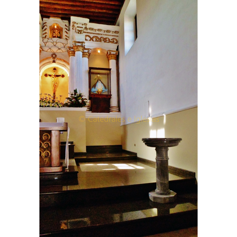the modern font located near the altar