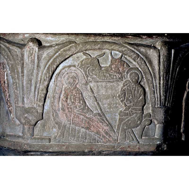 on the west side of the basin -- Joseph sits to the right. He is in the dream pose. His right hand supports his head and his left rests on his left knee. The Virgin is propped on her right elbow and either supports her head on her right hand or is just leaning against it. Her left hand is resting across her lap. The child is lying in a manger above with the two animals, on the right the ox and to the left the ass. Jesus in manger, swaddled, haloed and no limbs visible. There is no star.