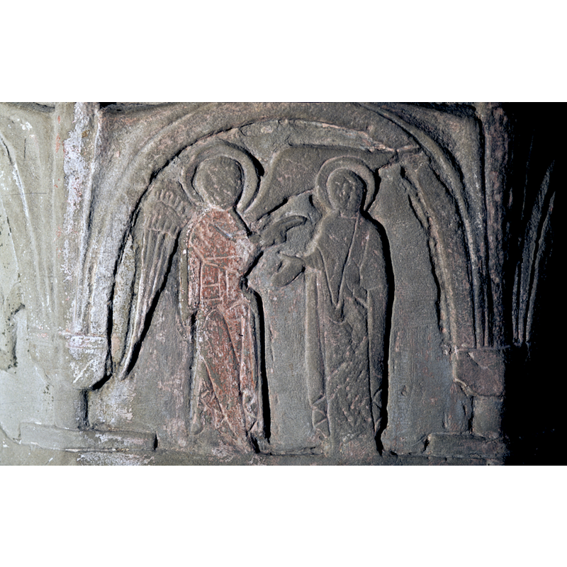 on the north side of the basin -- This might be the prophesy to Zacharias. A man is standing to the right of an angel. His hands are actively engaged in discussion. The Angel, to the left, is haloed and two winged. With his right hand he points to the man. This carving gesture/style is very much like that seen in Ottonian mss illuminations. Check this out - and in fact the wings too have the same animated appearance. Perhaps Byzantios is more Westphalian than Eastern.