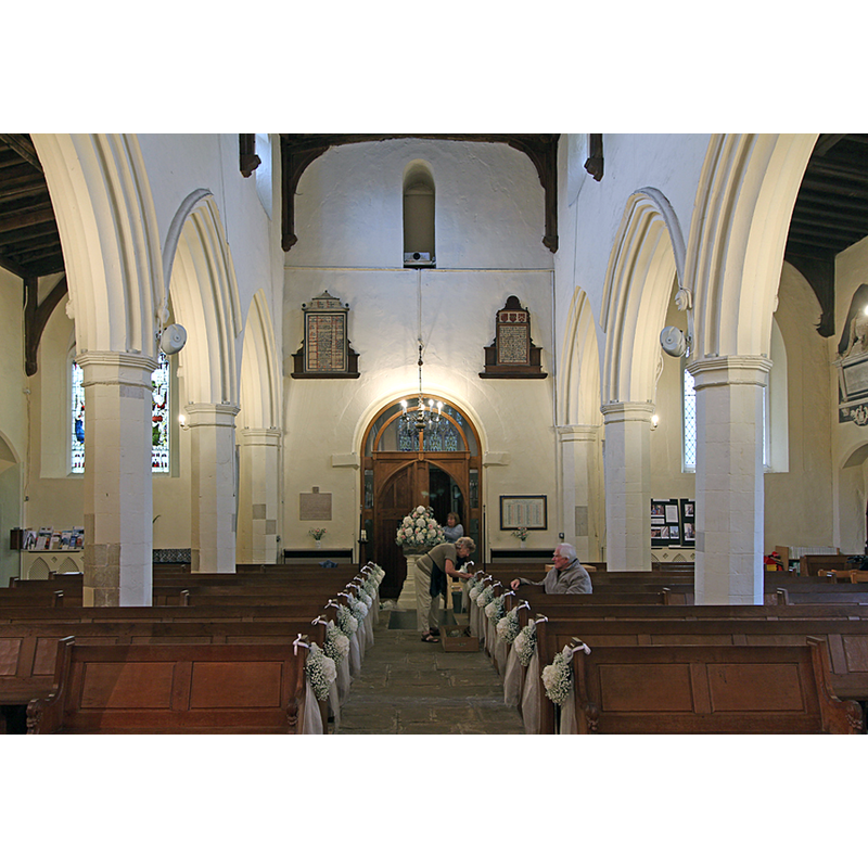 the font being decorated at the far [west] end of the centre aisle