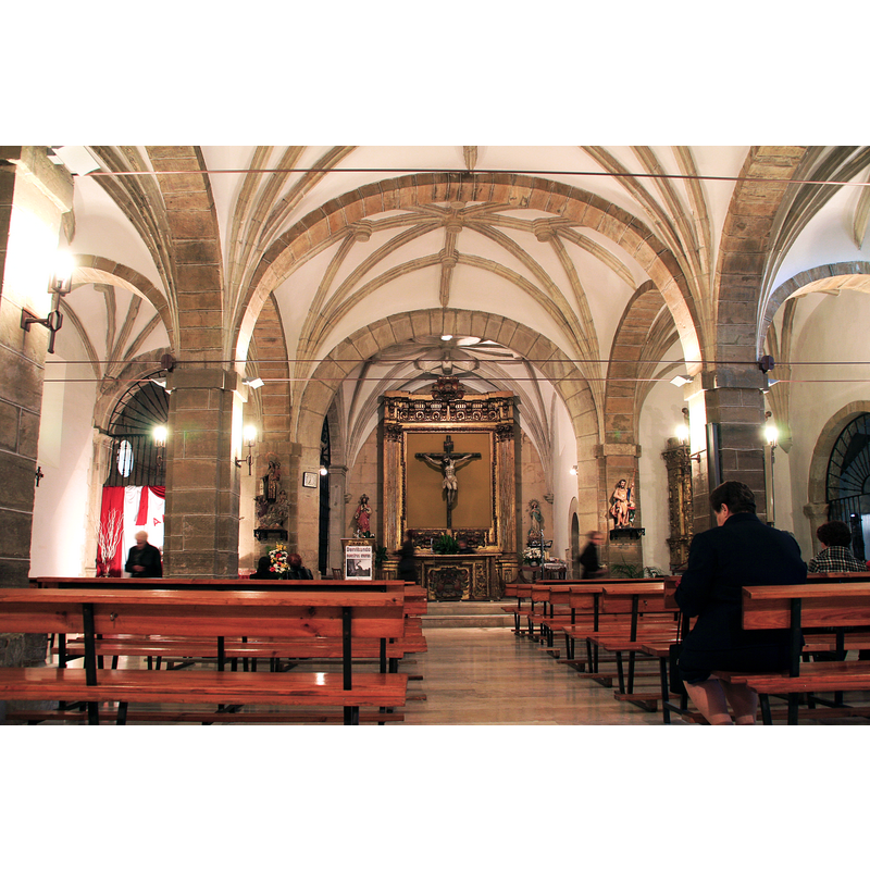 the font, though not visible in this image, is located at the east end of the north aisle, where the red and white drapings are