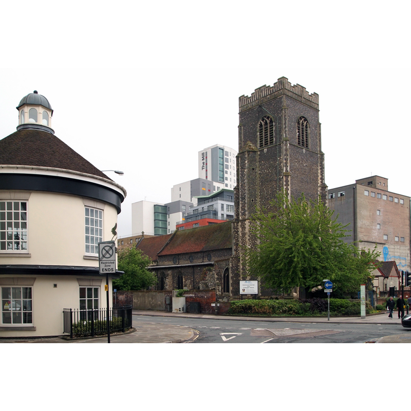 Source caption: "The circular building on the left, at the junction of St Peter's Street with this one-way section of Star Lane, is part of a more traditionally-shaped building occupied by Seven plc, a property company. Opposite it is the St Peter's-by-the-Waterfront Heritage and Culture Centre (the Augustinian Priory of St Peter & St Paul founded by Henry I in 1130 that finally served as a parish church prior to being made redundant). The graffiti-marked building behind the former church is the dilapidated R & W. Paul malt silo and to the left of the church tower, amongst the other modern blocks, is "The Mill", a mixed-purpose block."