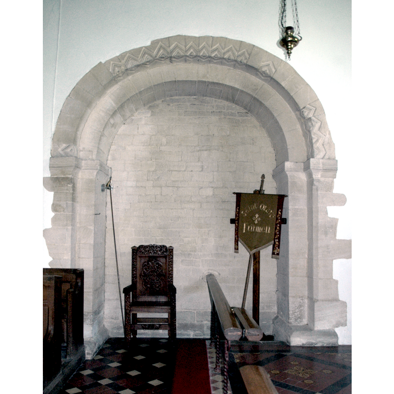Source caption: "Norman chancel arch, relocated in 1865 to the north side of the chancel."