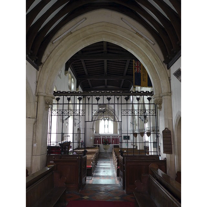 view of the nave and west end through the chancel arch; the modern font is visible at the far end