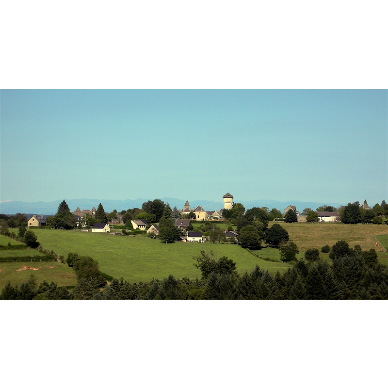 the tower of the church, dwarfed by the water tower, in the centre of the image