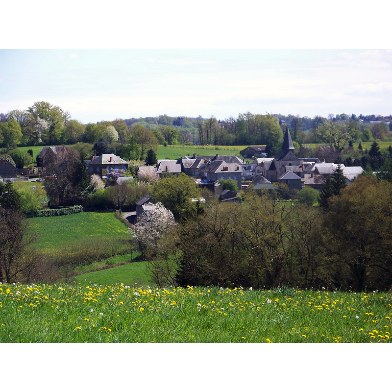 the spire of the church towers above the village, centre right