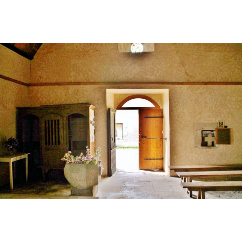 the interior of the modern church with the stone baptismal font in the foreground
