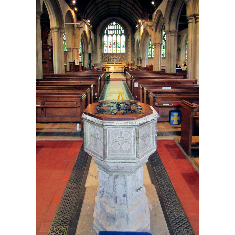 the font and cover at the west end of the nave, centre aisle