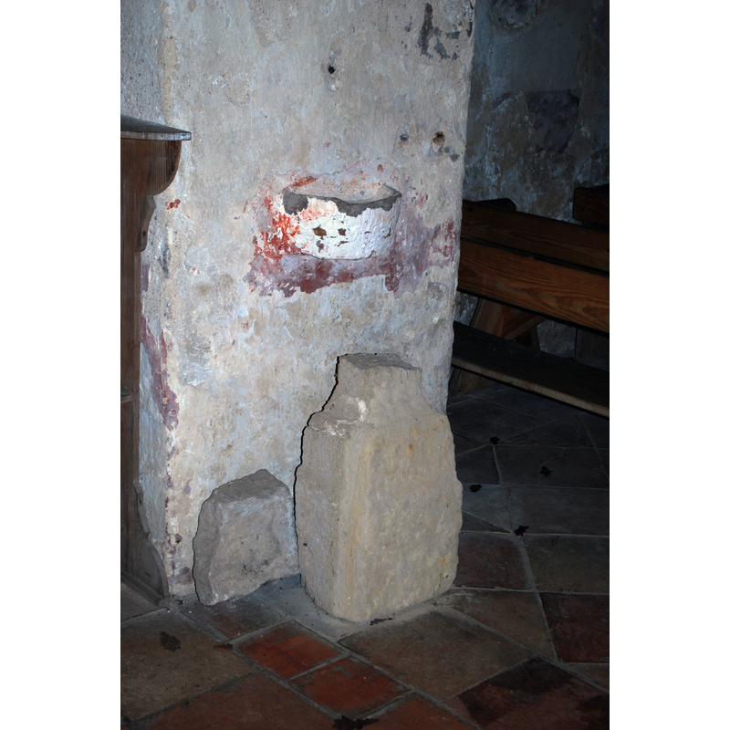 one of two wall-mounted stoups at the west end of the nave, on a pillar of the tower arch