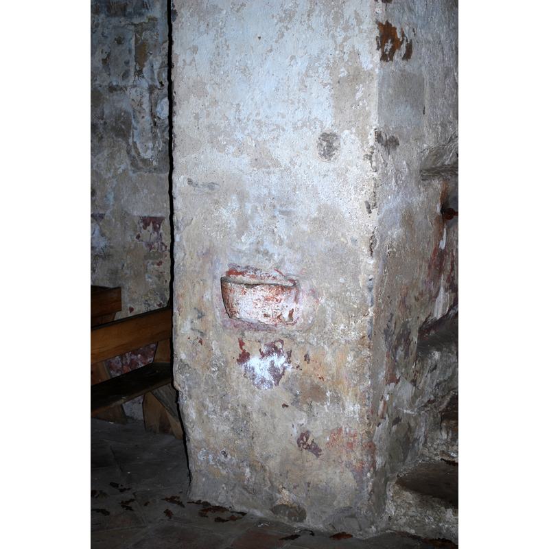one of two wall-mouted stoups at the west end of the nave, on a pillar of the tower arch