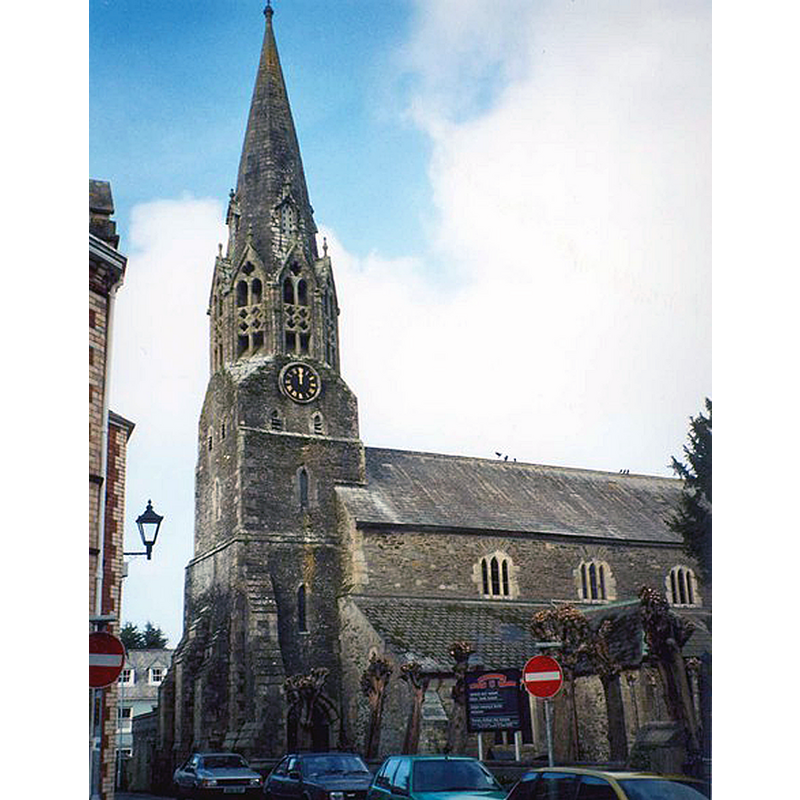 Source caption: "St Bartholomew's Church, Lostwithiel. St Bartholomew was the patron saint of tanners. The tower is 13C according to Pevsner, with a spire that has been replaced from time to time; the transition to an octagonal shape was made in the 14C. Originally the footway alongside the road passed through the ground-floor of the tower."