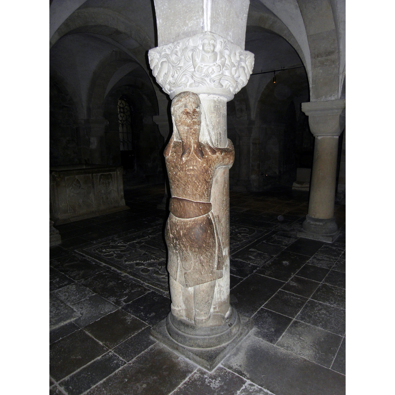 Source caption: "A pillar in the crypt of Lund Cathedral with a man embracing it. Local legend tells that the figure is Finn the Giant."