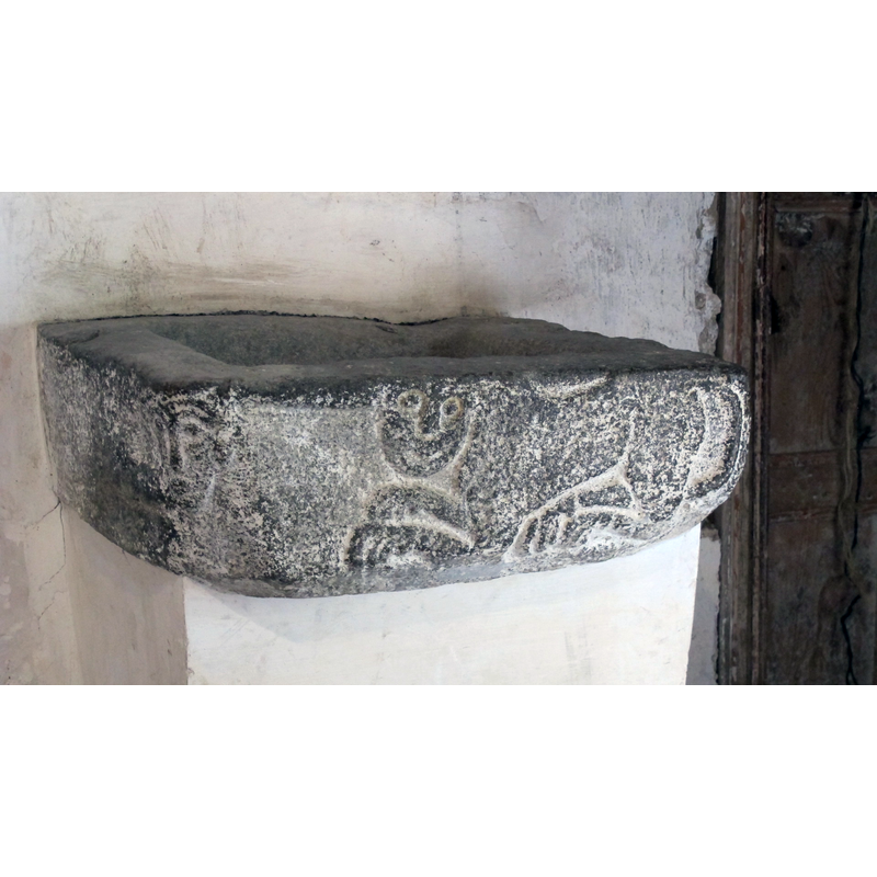 located to the left of the doorway