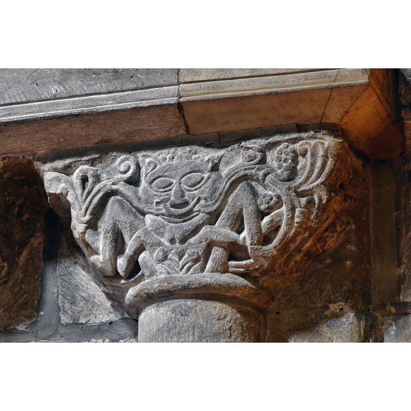 a lion with vegetation stemming from its mouth, a classic of Norman sculpture, as is the interlace below the head