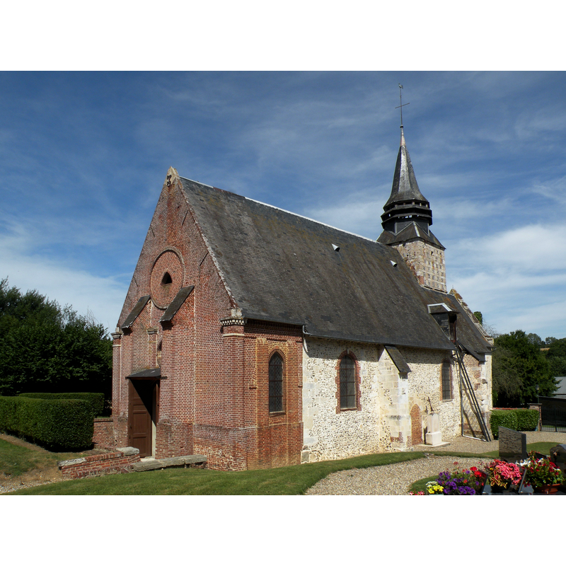 the old nave and chancel in stone, the west extension in brick