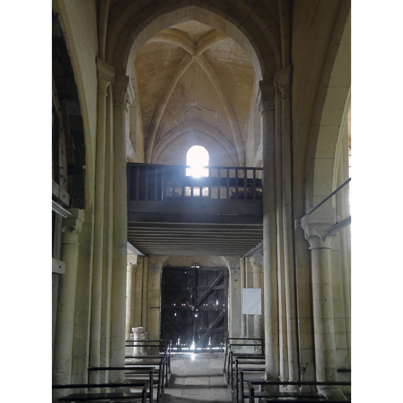 the holy-water stoups can be seen at the far end, left side -- Source caption: "Nef, deuxième travée, vue vers l'ouest."