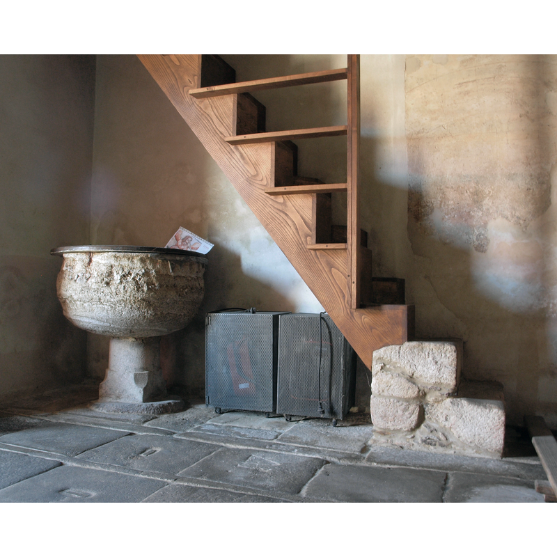 the font in the northwest corner of the nave, beneath the gallery stairs