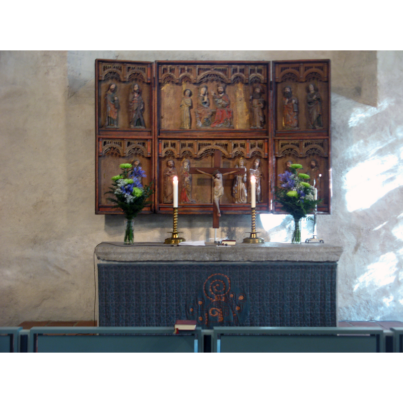Source caption: "Altarpiece from Lübeck, made in the 15th century, and altar in Saint Mary's Church, Maaria. Several figures are missing. The crucifix is from the 14th century, possibly of domestic origin".