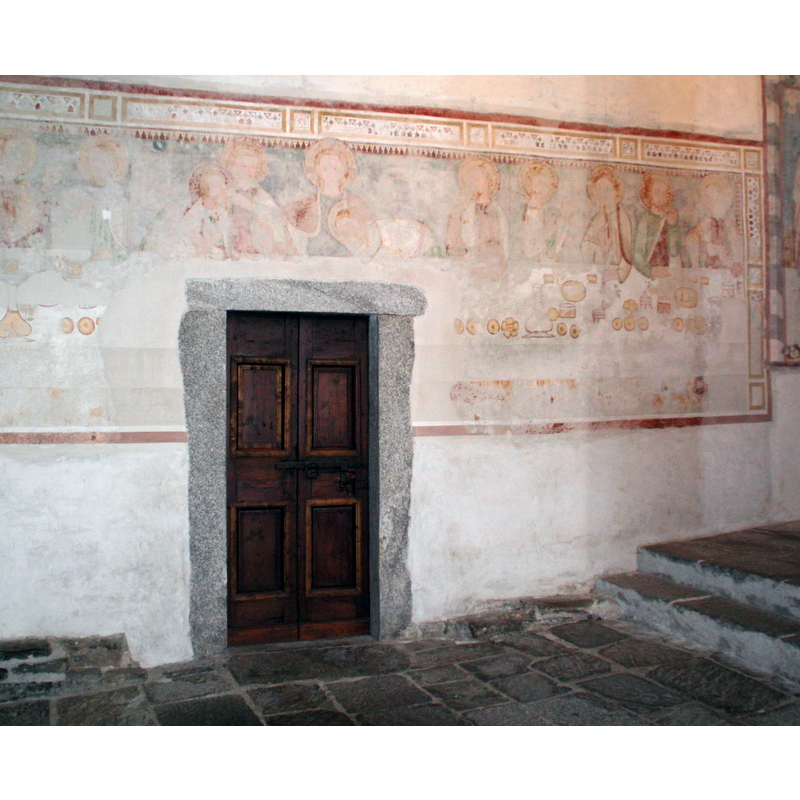 painting on the north wall framing the sacristy doorway: the Last Supper