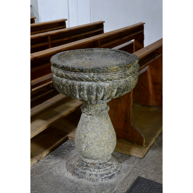 the modern stoup located by the west entranceway of this church