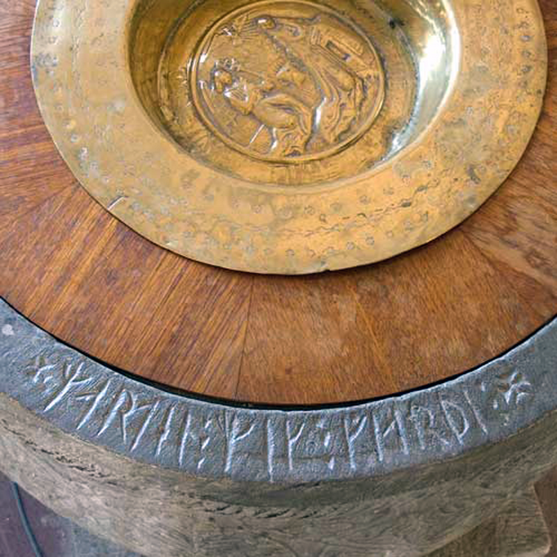 showing the Runic inscription and the baptismal dish used for baptisms