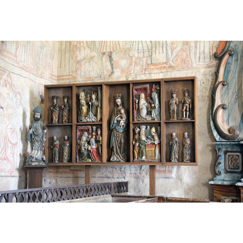 a collection of late-medieval (15th-16thC?) wooden statues at the east end, north side, left of the altar