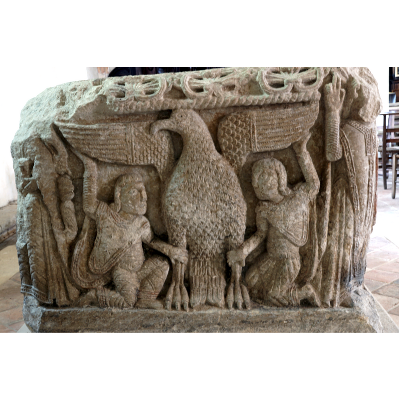 a large eagle, the open wings and the legs being held by two humans -- on the west side of the basin