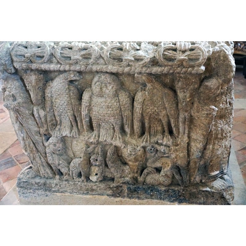 the east side of the basin has two levels: the upper level has an owl with an eagle on either side; at the extreme ends goat or ram heads have human legs dangling from their mouths; the lower level has fabulous animals (winged sirens, dragons)