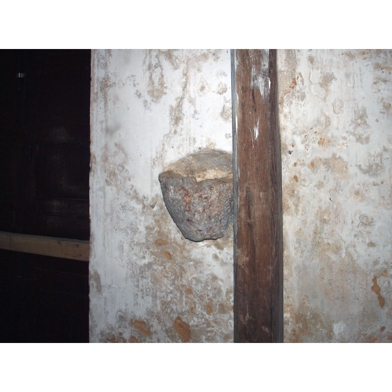one of two stone holy-water stoups; this one to the right of the west entranceway
