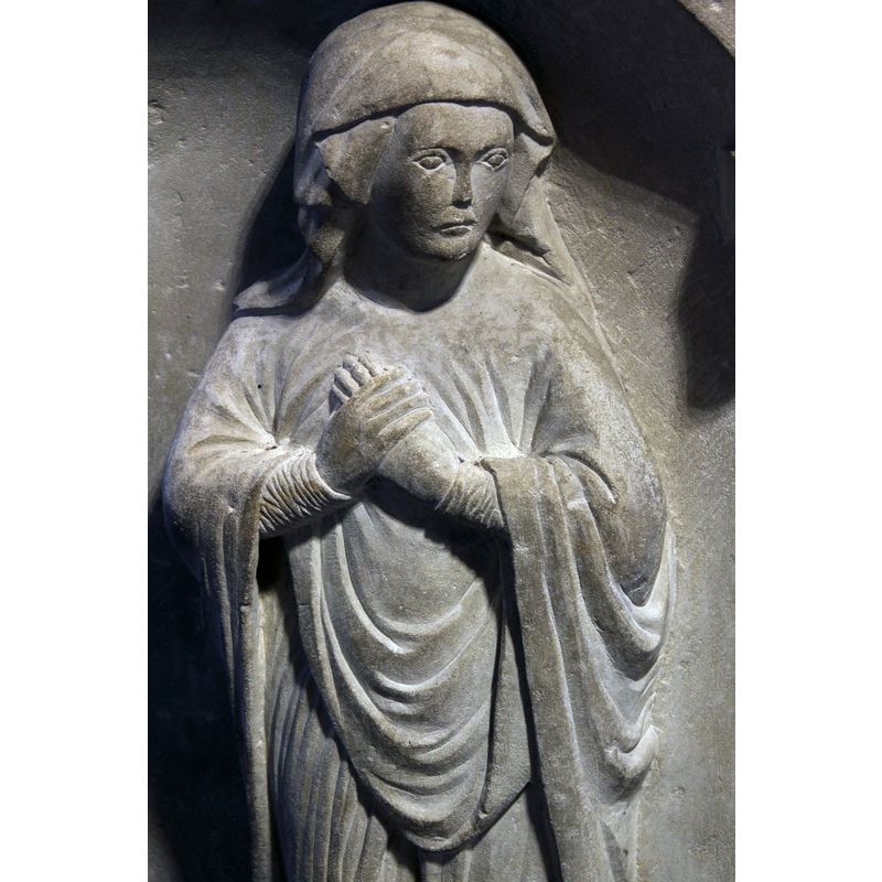 Mary holds her left hand with her right, a medieval symbol of grief
