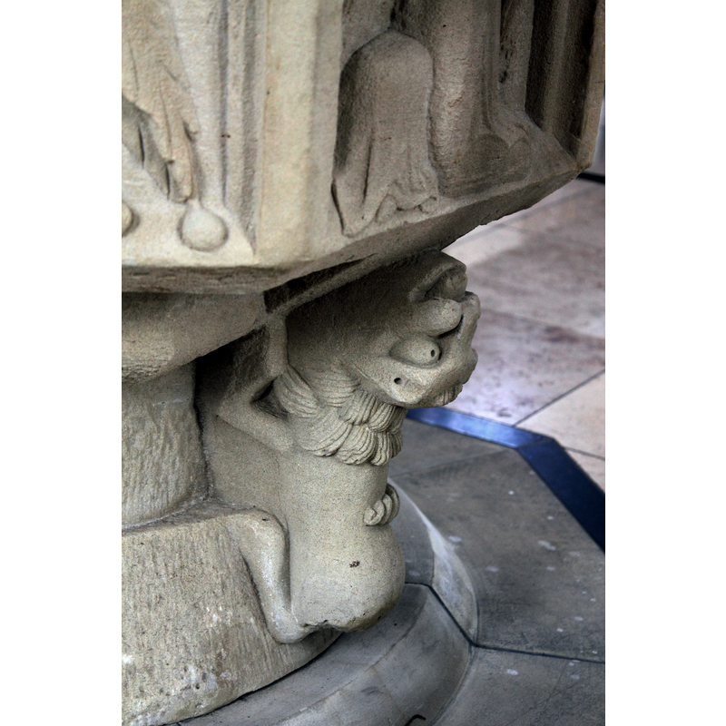 located below one of the two turiferary angels of the basin