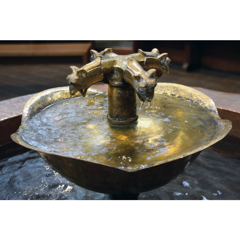 a fountain within the metal insert atop the old font