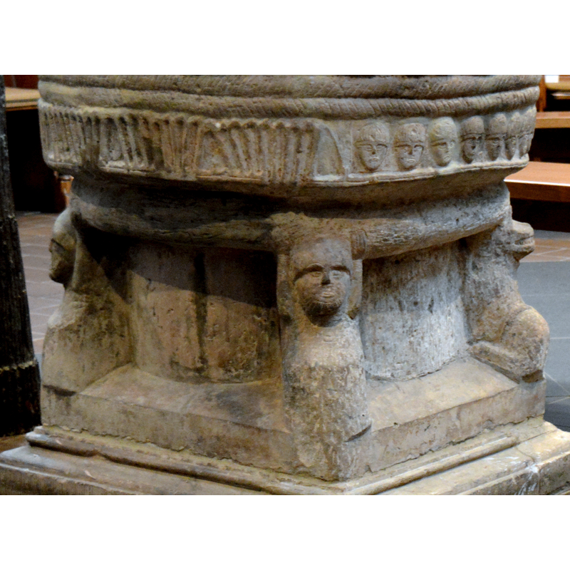 in the centre of the image a human figure in atlante position holds the thick moulding of the base