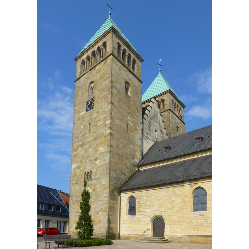 the saddle-back tower top has been preserved, dwarfed now by the 20thC twin towers