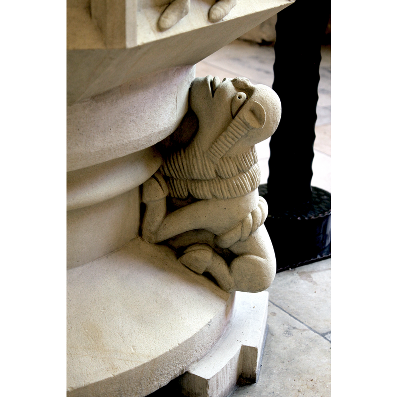 one of four animals on the base, this one below the third Magus, on the northwest side; the hooves are ovine/bovine, but the mane and the tail over the rump suggest a lion