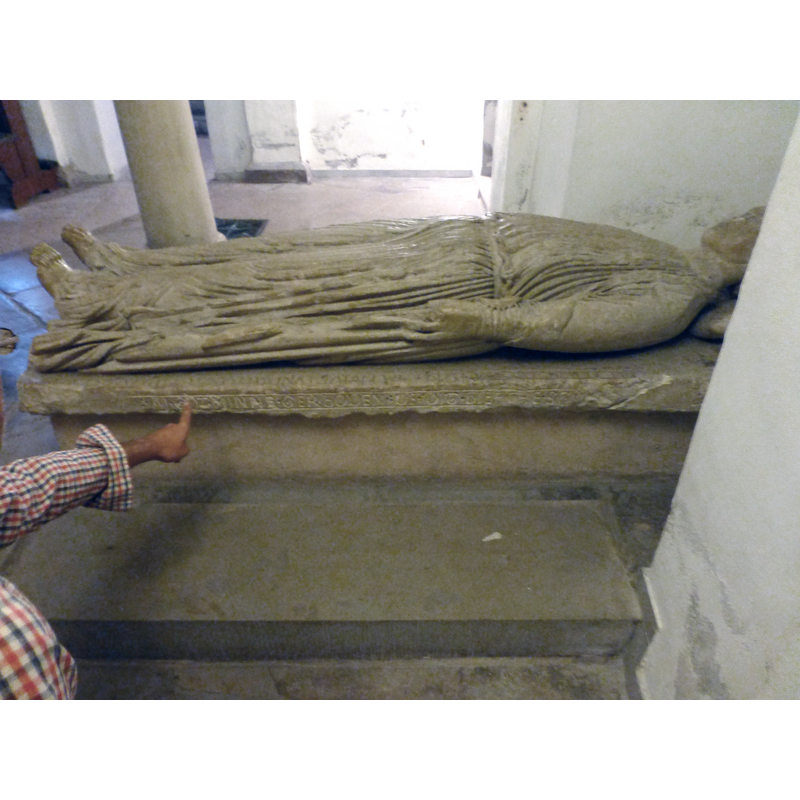 the 13thC (?) tomb of Geva, wife of 9thC Saxon lord Everward -- the finger points to the part of the inscription that is claimed to share special characteristics with the inscription on the font