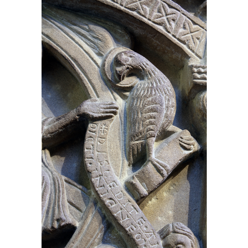 John's symbol and inscribed scroll; extra wings above the eagle's haloed head