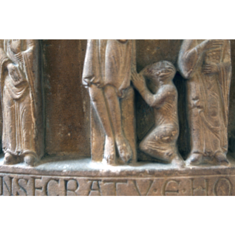 a bearded figure kneels to the left of the cross; a patron?