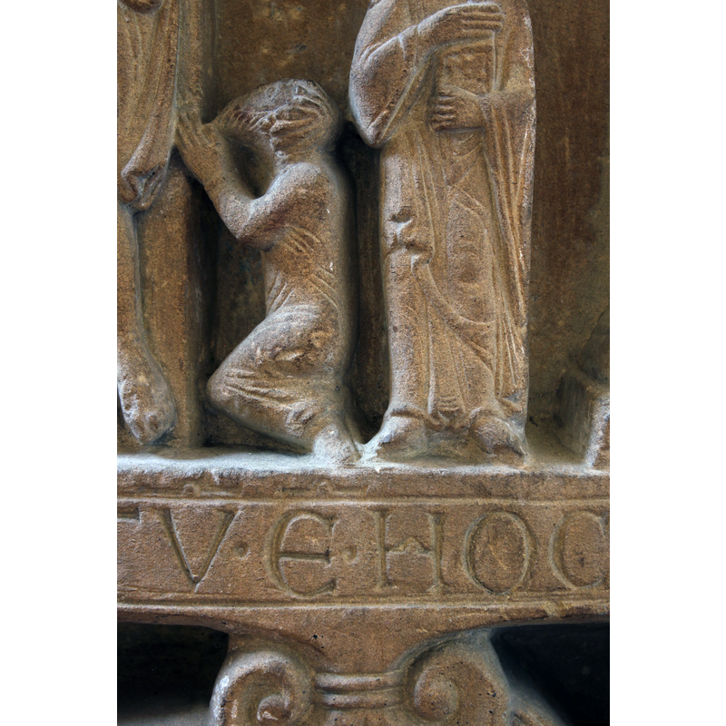 a bearded figure kneels to the left of the cross; a patron?