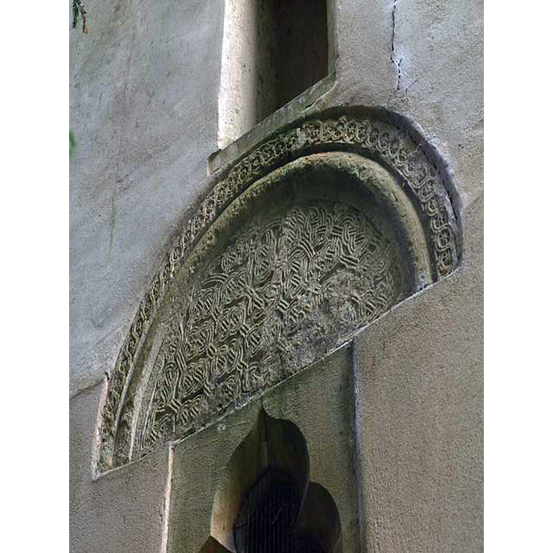 Source caption: "Cletic [sic] knotwork tympanum at the ewest side of the tower" [NB: the CRSBI entry [www.crsbi.ac.uk/site/749/] [accessed 1 November 2017] has: "The tympanum is reused as an external lintel over the late medieval window in the ground stage of the W wall of the tower. It is covered with three-strand figure-of-eight knot pattern, bordered by a roll-moulding and by a band of guilloche with the fields enclosing small stars."